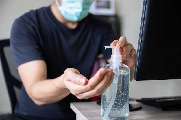 Man hand washing with sanitizer gel