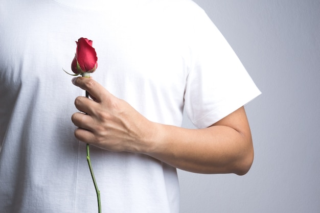 A man hand with red rose flower