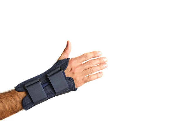 Man hand with therapeutic wrist brace to relieve wrist sprain pain