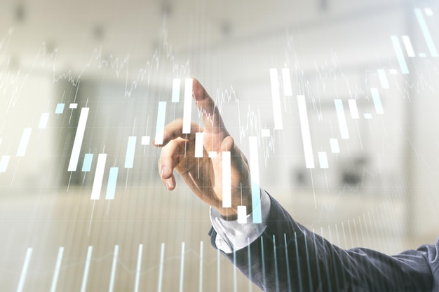 Man hand working with abstract virtual financial graph on blurred office background forex and investment concept Multiexposure