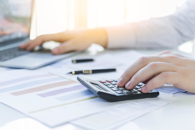 Man hands calculating at workplace