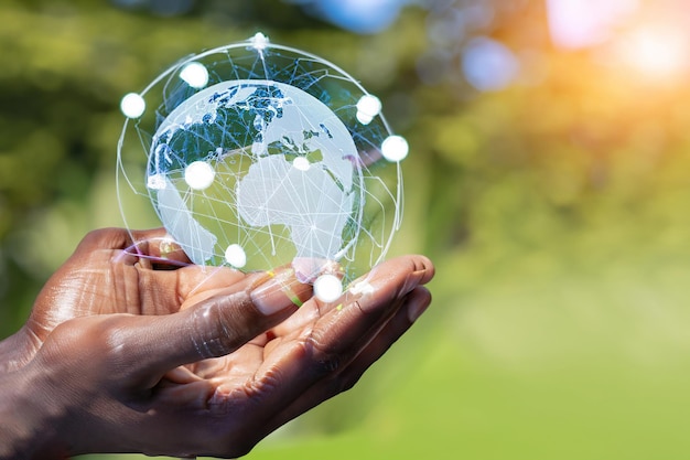 Man hands holding global network and data customer connection on nature background