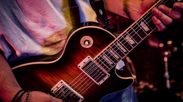 Man hands play guitar details of guitar strings and chords