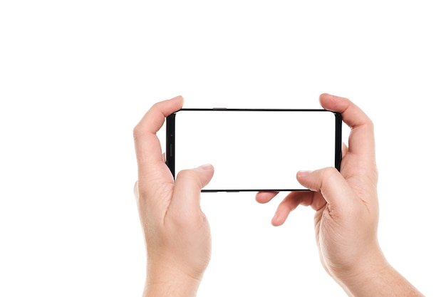 Man hands typing on the black smartphone blank screen with modern frameless design isolated on white background