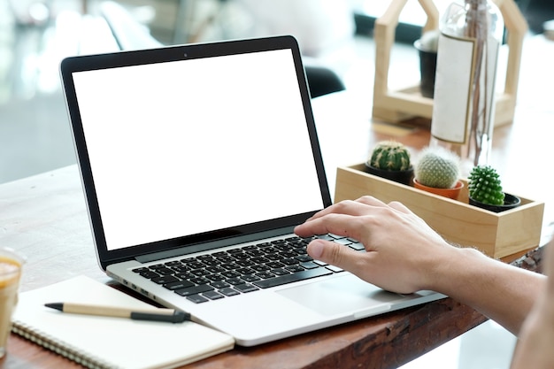 Man hands typing laptop computer with blank screen for mock up.