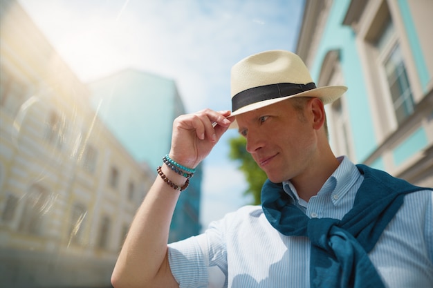 a man in a hat is walking around the city