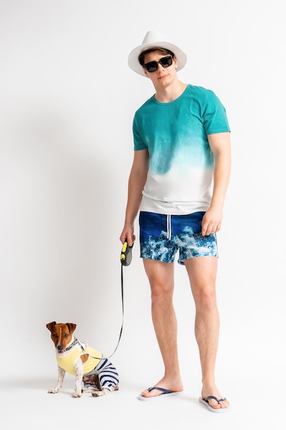 Man in hat sunglasses and beach outfit with Jack Russell Terrier dog