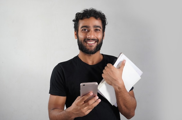 Man having books and mobile