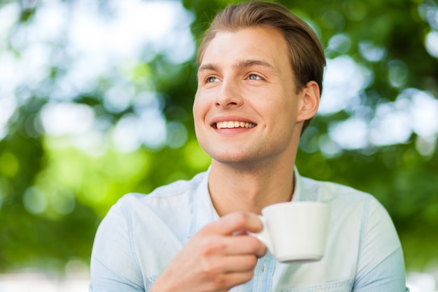 Man having a cup of coffee outdoor