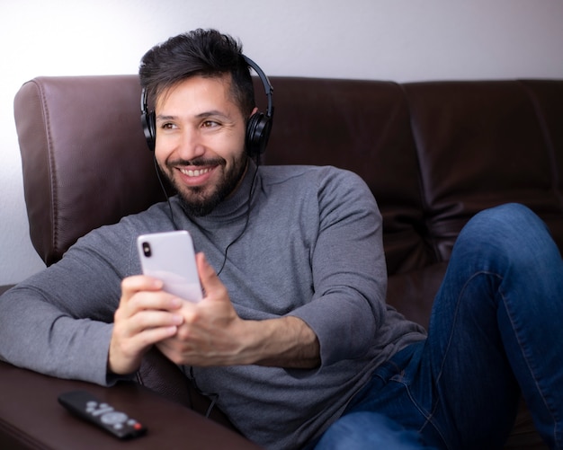 Man having fun looking at smartphone with headphones