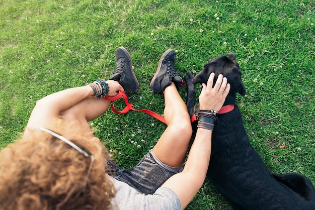 Man having fun and playing with his dog in the park.