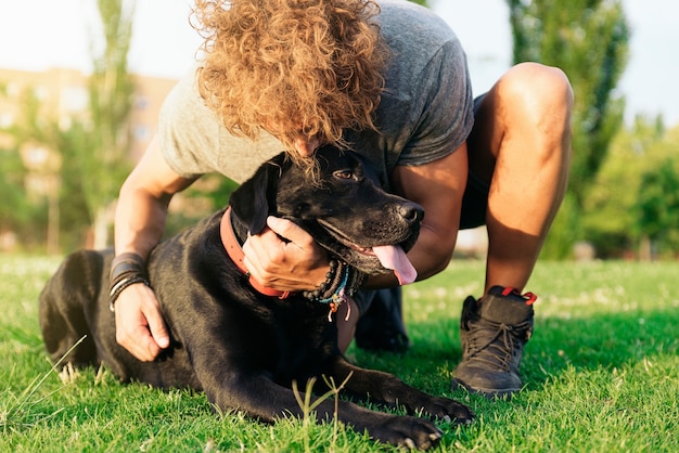 Man having fun and playing with his dog in the park.