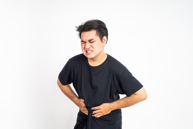 Man having stomachache holding his stomach with two hands