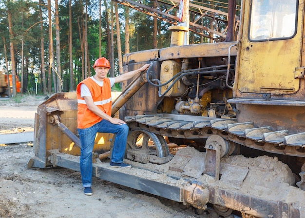 Man in  helmet driver  construction equipment