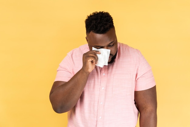 Man hiding face in hand with white handkerchief crying feeling stressed worried facial expression