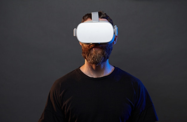 Man hipster with beard using virtual reality glasses