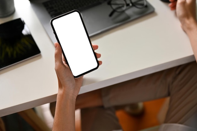 A man at his office desk using a smartphone Cellphone white screen mockup