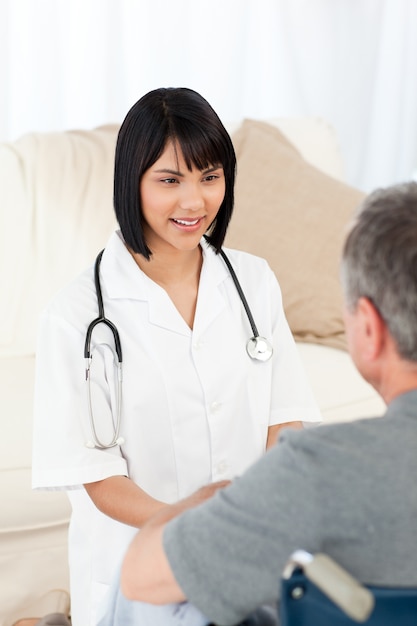 Man in his wheelchair with his nurse at home