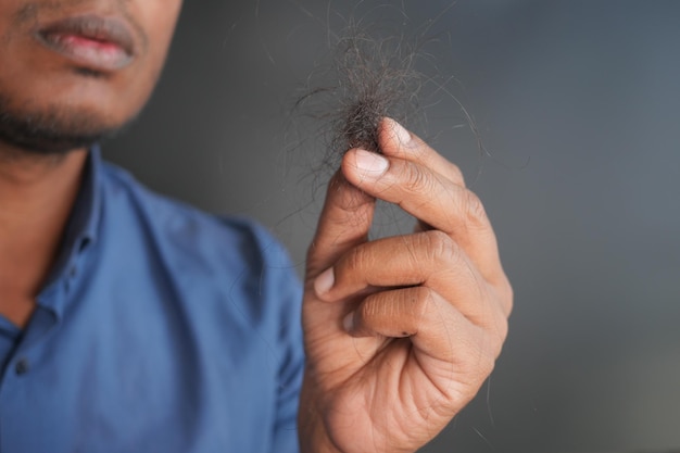 man hold his list hair close up