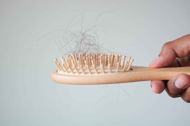 Man hold his list hair close up