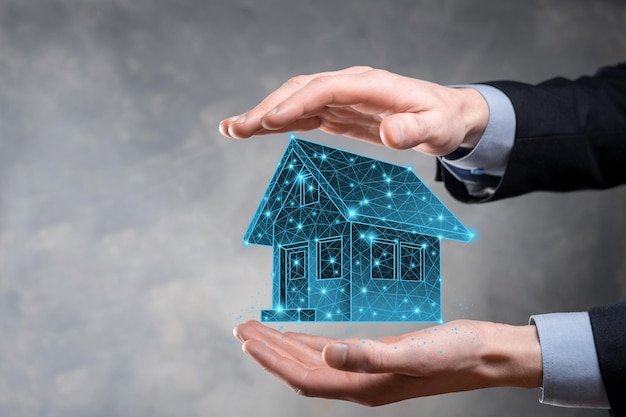 Man hold low polygon.Real estate concept, businessman holding a house icon.House on Hand.Property insurance and security concept. Protecting gesture of man and symbol of house