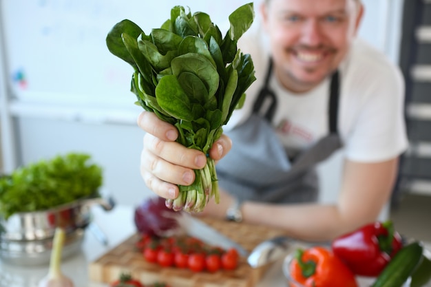 Man hold useful bunch of spinach in hand