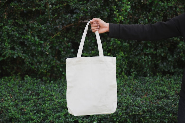 Man holding bag canvas fabric for mockup,ecology Concept.