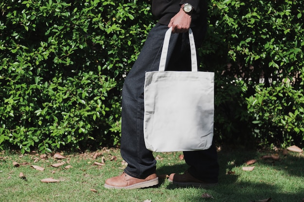 Man holding bag canvas fabric for mockup,ecology Concept.