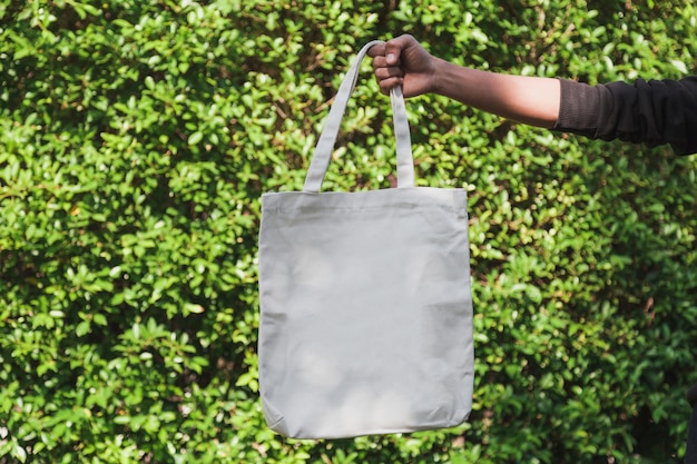 Man holding bag canvas fabric for mockup,ecology Concept.