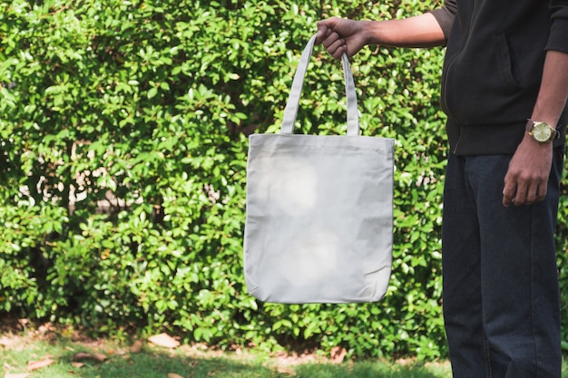 Man holding bag canvas fabric for mockup,ecology Concept.