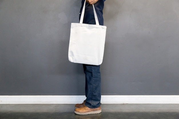 Man holding bag canvas fabric for mockup,ecology concept.