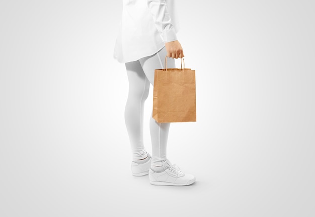 Man holding blank brown craft paper bag