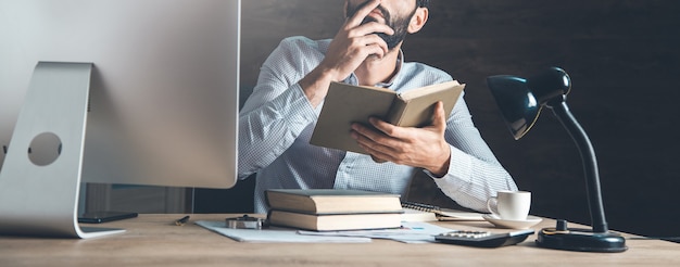 Man holding a book at the office