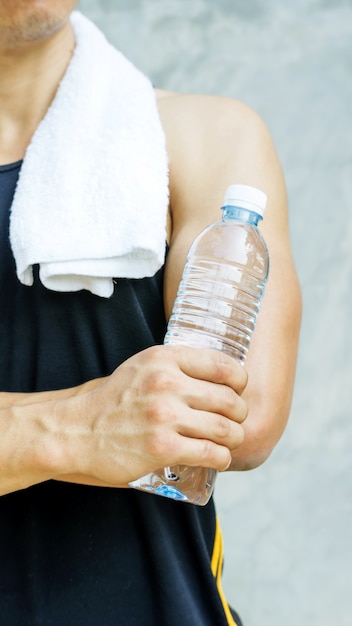 Man holding a bottle of water.