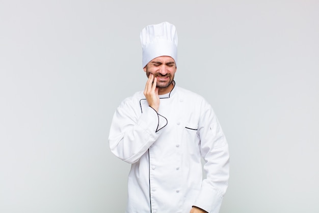 Man holding cheek and suffering from painful toothache