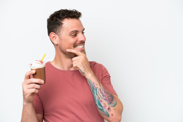 A man holding a coffee drink with a coffee cup that says'coffee'on it