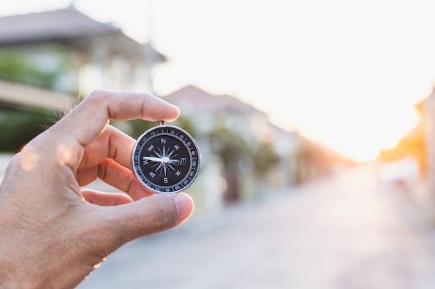 Man holding compass on blurred background. for activity lifestyle outdoors freedom or travel tourism and inspiration backpacker alone tourist travel or navigator image.