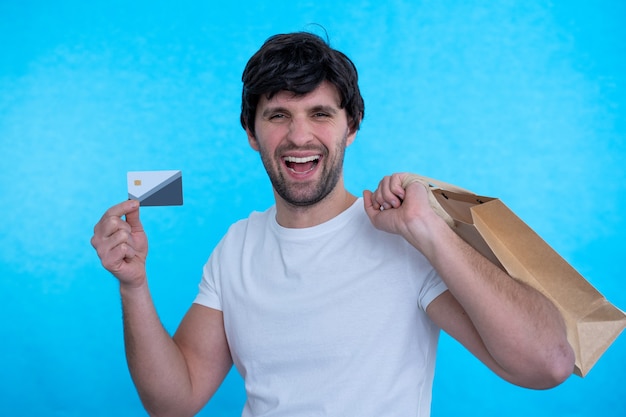 Man holding credit card and shopping bags