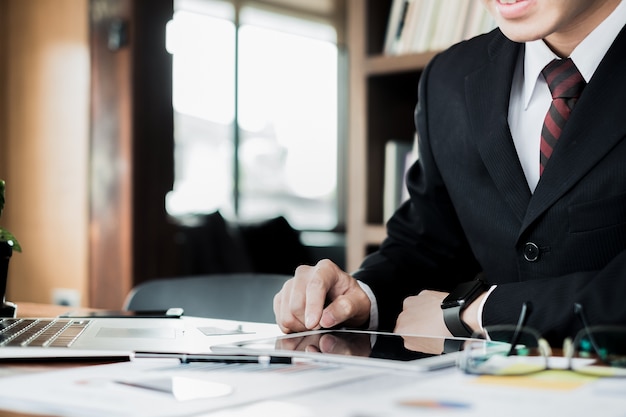 man holding credit card and using laptop and smartphone shopping website online