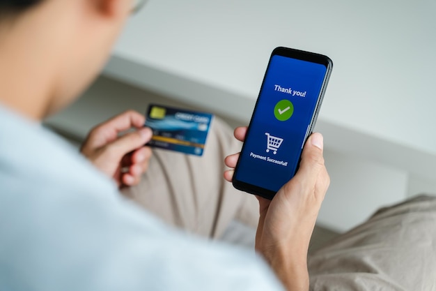 Man holding credit card and using smartphone for online shopping internet banking ecommerce