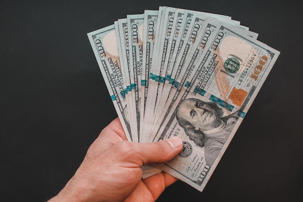 Man holding dollars in his hand