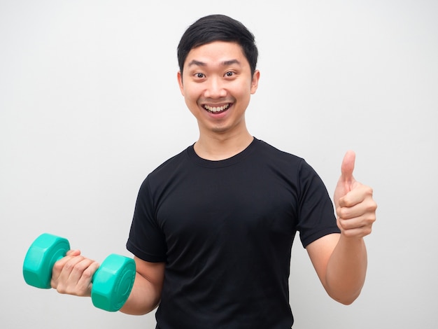 Man holding drumbbell with happy smile thumb up motivation workout concept