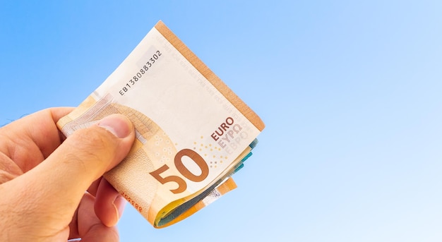 A man holding Euros banknotes