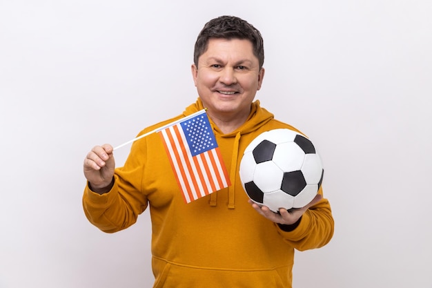 Man holding flag of united states of america and soccer black and white ball united soccer league