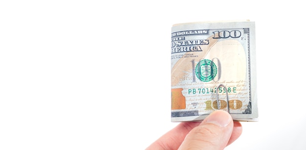 a man holding folded US dollar bills on a white background