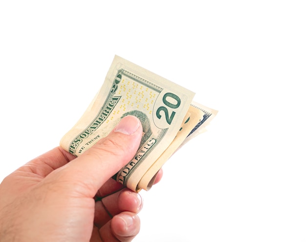 a man holding folded US dollar bills on a white background