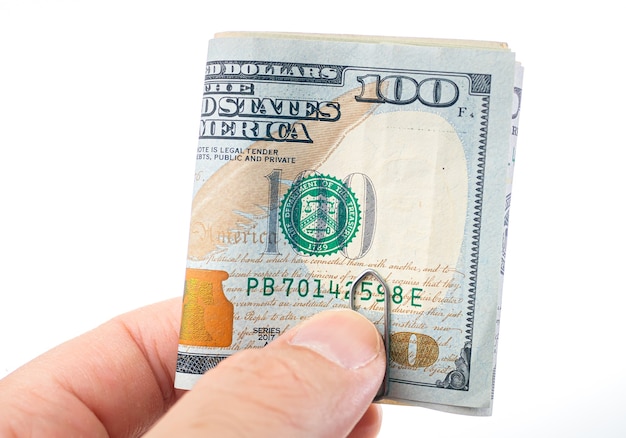 a man holding folded US dollar bills on a white background