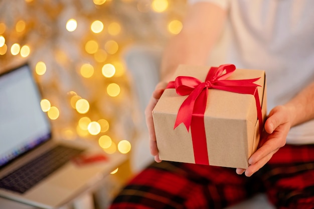 man holding gift in his hand on bokeh background