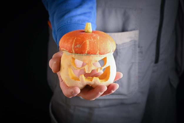 Man holding in hand freshly pumpkin closeup Carving A Pumpkin For Halloween