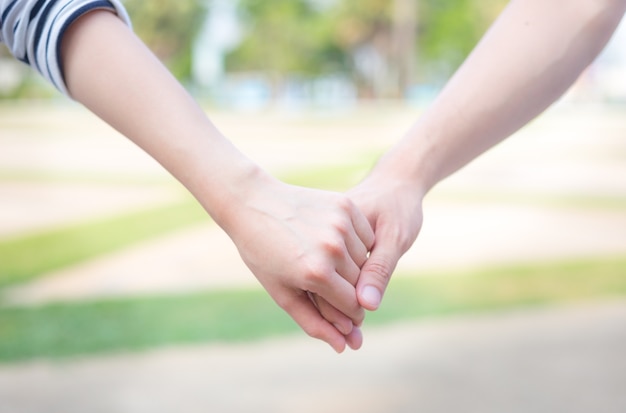 man holding hand of woman